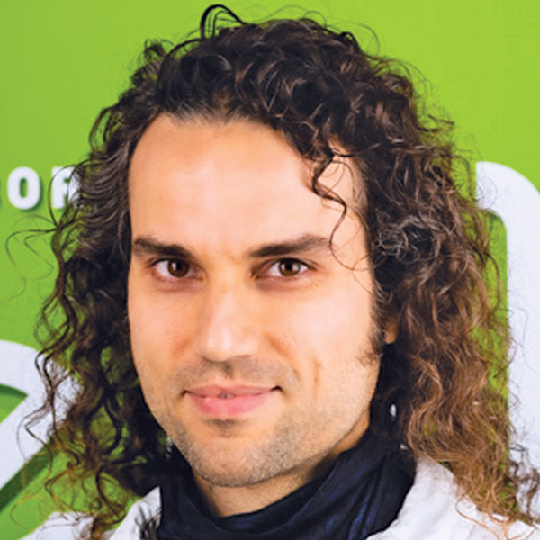 Headshot of Arnaud in front of green background